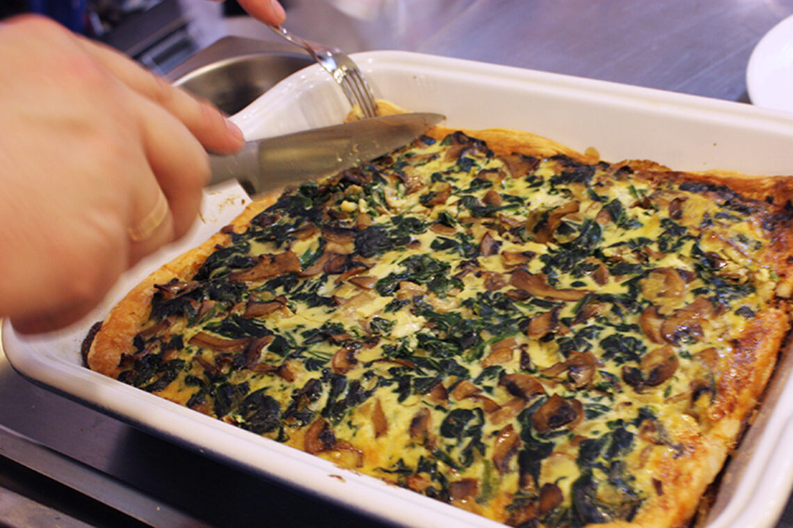 Spinach and mushroom quiche. Culinary school recipes of of world-famous dishes.